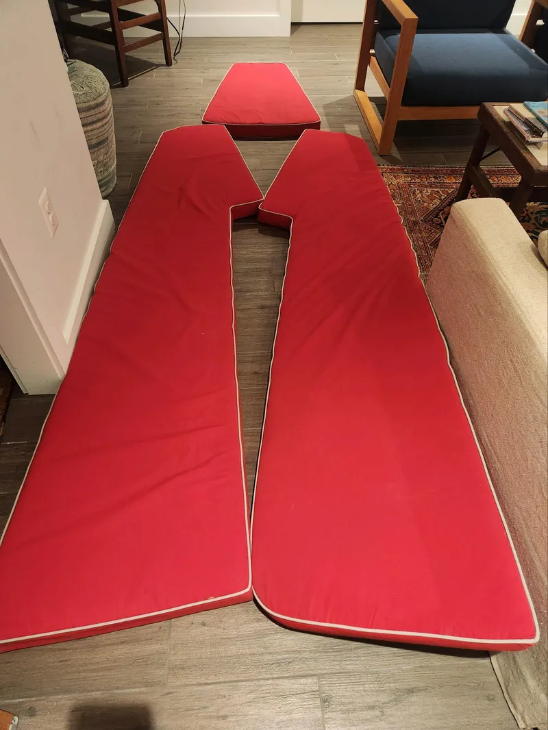 Slide: The Image of Red cushions on a wooden floor, possibly for a boat. - 32