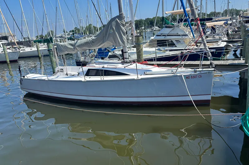 The Image of 2015 Catalina 275 Sport sailboat docked in a marina, surrounded by other boats. - 0