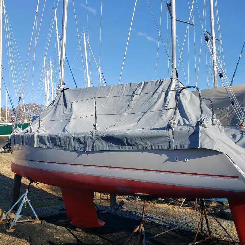 Slide: The Image of A 2015 Catalina 275 Sport is on a stand on land, covered with a gray tarp. - 11