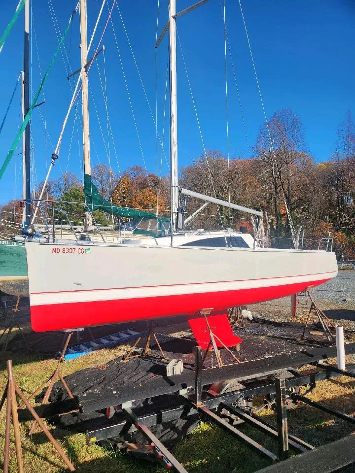 Slide: The Image of A 2015 Catalina 275 Sport sailboat is on a stand on land. - 5