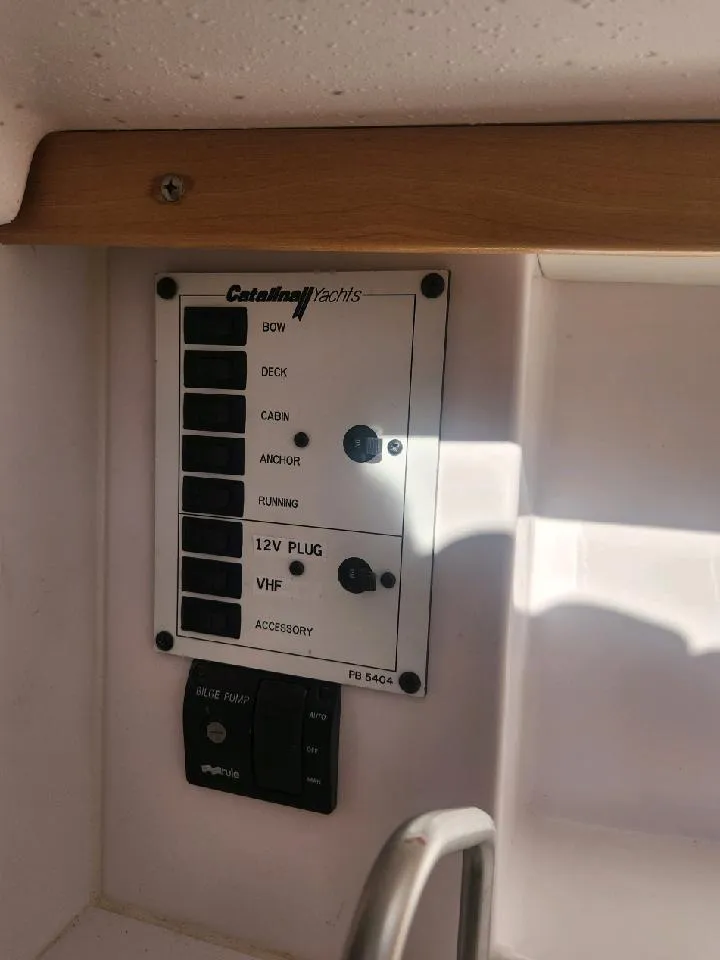 Slide: The Image of A control panel with various switches and a VHF switch aboard a Catalina 275 Sport. - 26