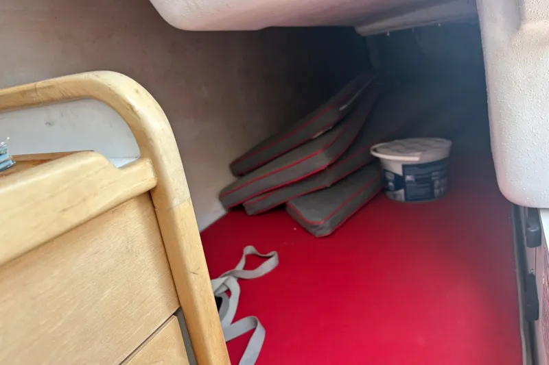 Slide: The Image of Interior cabin of 2015 Catalina 275 Sport with red flooring and storage items. - 38