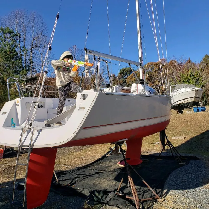 Slide: The Image of A 2015 Catalina 275 Sport is on dry dock. A person is working on board. - 8