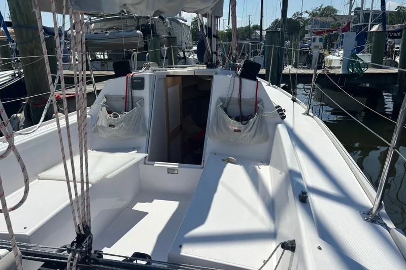 Slide: The Image of 2015 Catalina 275 Sport sailboat cockpit with seating, docked at a marina. - 13