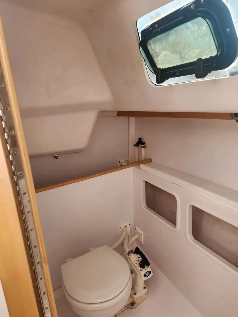Slide: The Image of Interior view of a boat cabin with a toilet and window. - 30