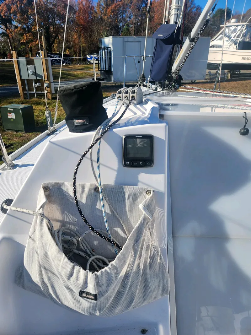 Slide: The Image of The deck of a 2015 Catalina 275 Sport with sailing gear and a control device. - 16