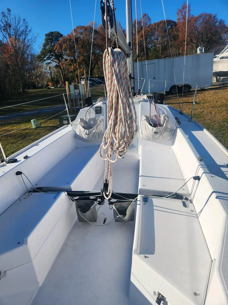 Slide: The Image of The image shows the cockpit of a 2015 Catalina 275 Sport with clear seating areas. - 12