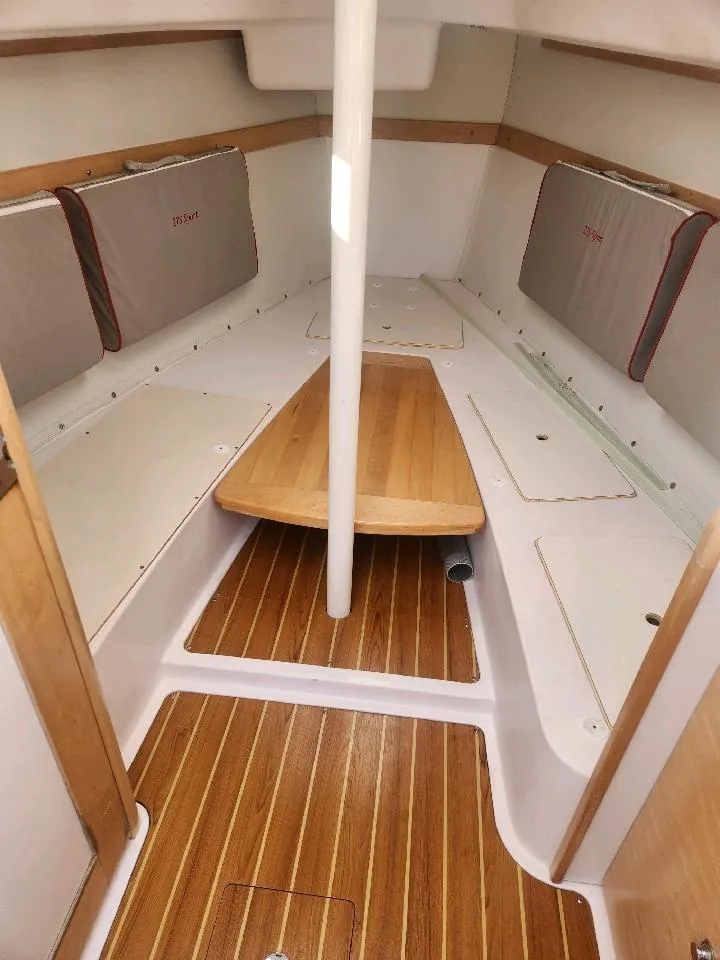 Slide: The Image of Interior of a 2015 Catalina 275 Sport with wooden flooring and seating. - 20