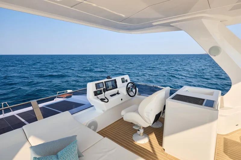 Slide: The Image of Luxurious 2025 Omaya 50 Power Catamaran helm with ocean view and modern controls. - 46