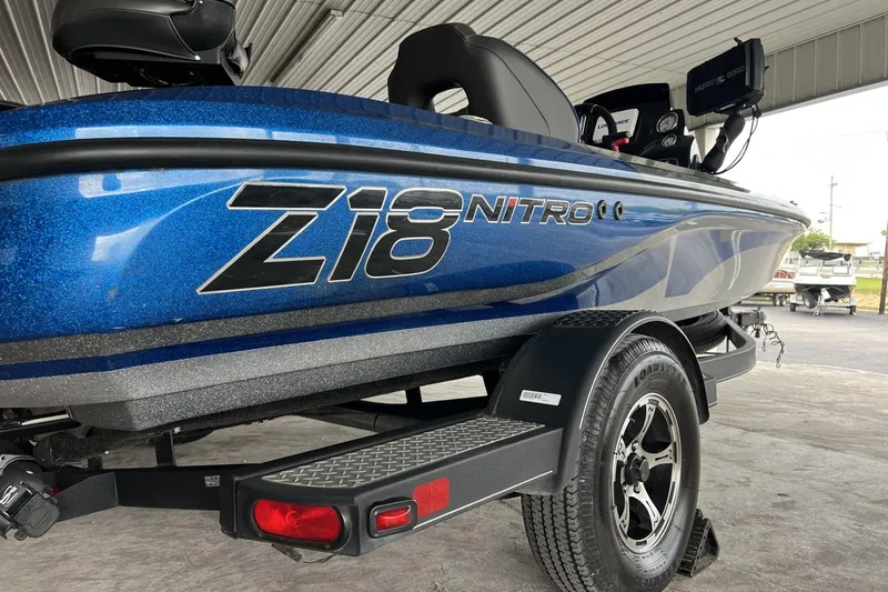 Slide: The Image of Blue 2018 Nitro Z18 boat on trailer, under a metal roof. - 2