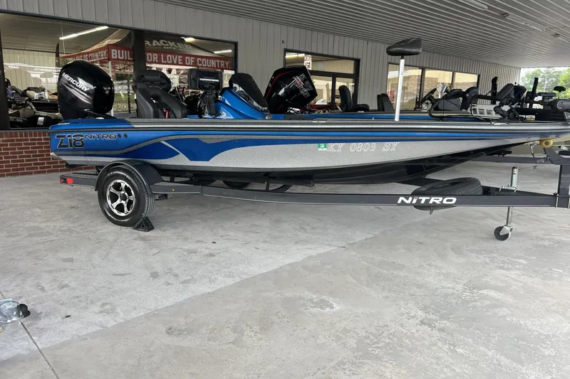 The Image of 2018 Nitro Z18 boat with trailer, displayed in a showroom setting. - 0