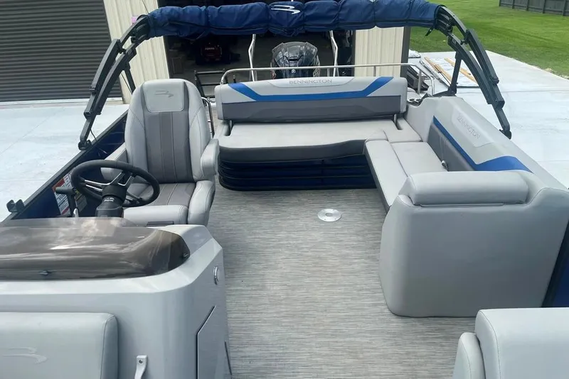 Slide: The Image of 2023 Bennington 23 SX pontoon boat interior with gray seating and steering console. - 6