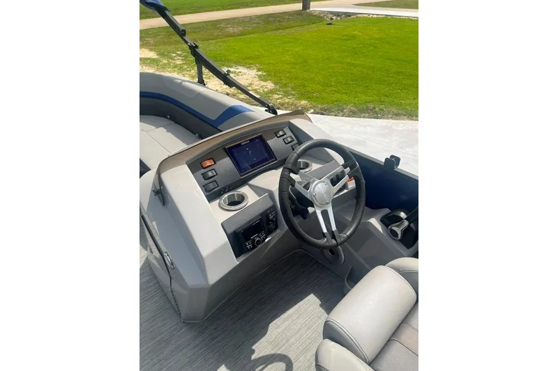Slide: The Image of 2023 Bennington 23 SX boat dashboard with steering wheel and control panel. - 7