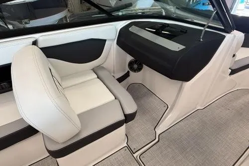 Slide: The Image of 2027 Regal 2000 ES boat interior with white and gray seating, modern dashboard. - 8