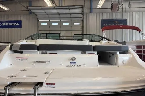 Slide: The Image of 2027 Regal 2000 ES boat in showroom, rear view with seating and open garage door. - 4