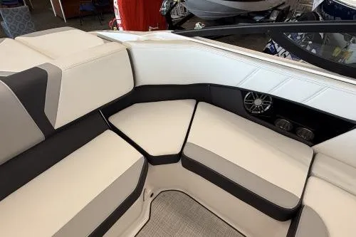 Slide: The Image of 2027 Regal 2000 ES boat interior with white and black seating, speaker, and cup holders. - 9