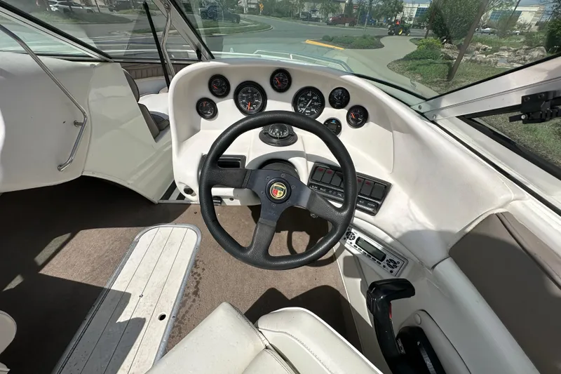 Slide: The Image of Interior view of a 1995 Mariah 180 Shabah boat dashboard with steering wheel and gauges. - 7