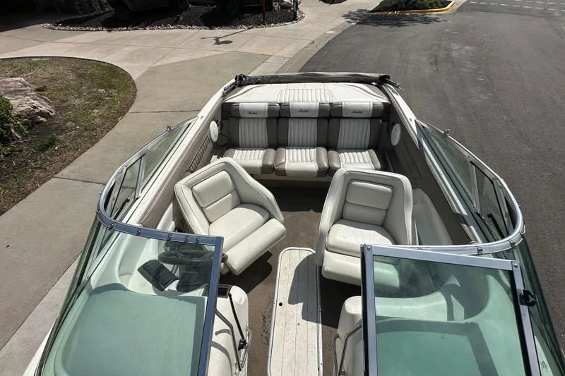 Slide: The Image of 1995 Mariah 180 Shabah boat interior with white seating and open deck layout. - 3