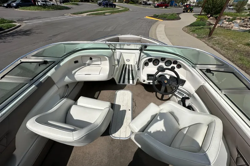Slide: The Image of Interior of a 1995 Mariah 180 Shabah boat with white seating and dashboard. - 9