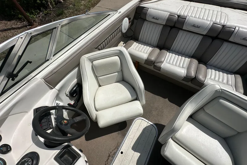 Slide: The Image of Interior of a 1995 Mariah 180 Shabah boat with white and gray seating. - 10