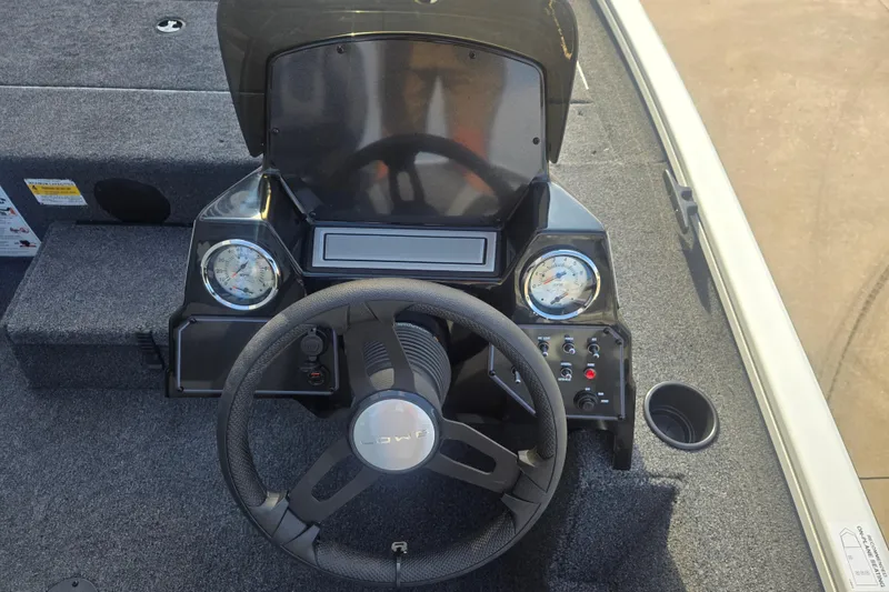 Slide: The Image of 2027 Lowe Stinger 175C boat dashboard with steering wheel and gauges. - 5