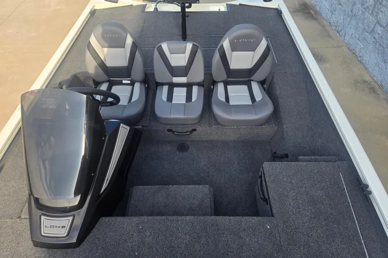 Slide: The Image of 2027 Lowe Stinger 175C boat interior with three gray seats and steering console. - 8
