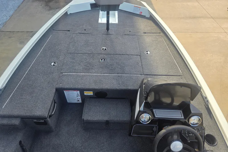 Slide: The Image of 2027 Lowe Stinger 175C boat interior with steering console and carpeted deck. - 6