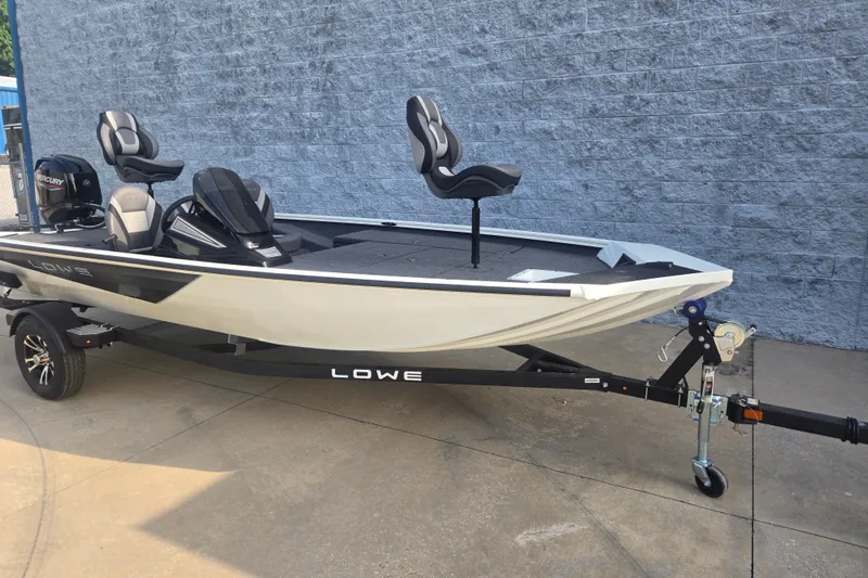 Slide: The Image of 2027 Lowe Stinger 175C fishing boat on trailer, featuring sleek design and modern seating. - 4