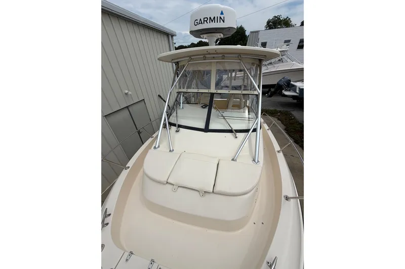 Slide: The Image of 2017 Grady-White Gulfstream 232 boat with Garmin radar, docked near a building. - 12