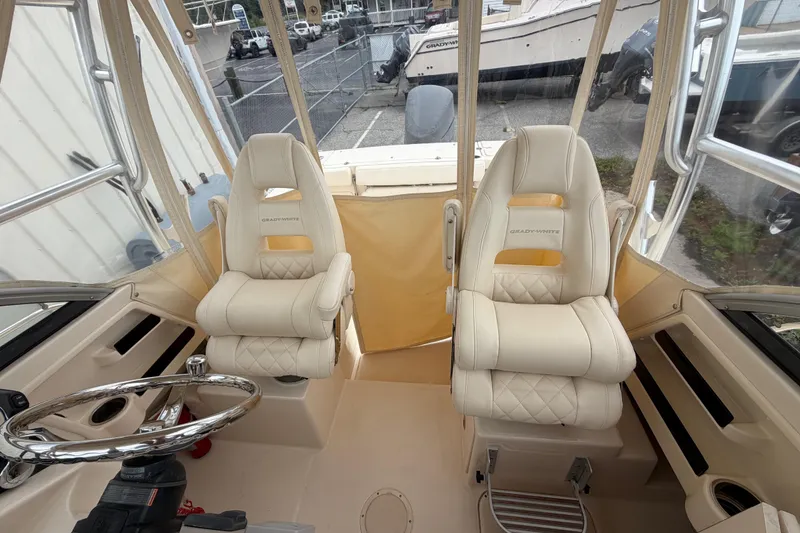 Slide: The Image of 2017 Grady-White Gulfstream 232 boat interior with dual cushioned seats and steering wheel. - 9
