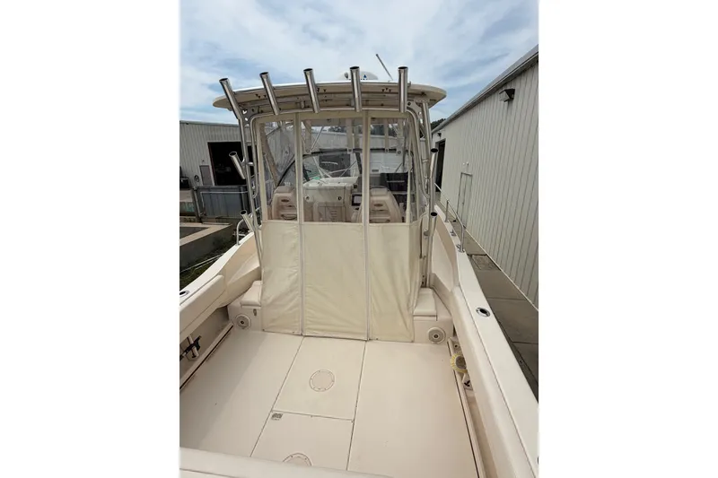 Slide: The Image of 2017 Grady-White Gulfstream 232 boat with enclosed cockpit, docked near a building. - 5