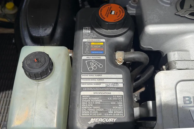 Slide: The Image of Close-up of a boat engine with technical details and specifications on a label. - 66