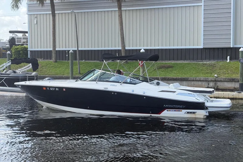 Slide: The Image of 2015 Monterey 288SS Super Sport boat docked on calm water. - 8
