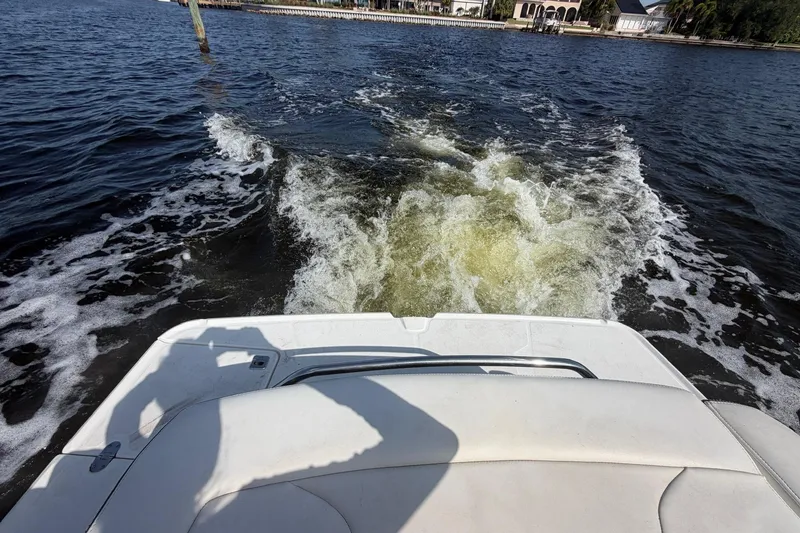 Slide: The Image of Rear view of 2015 Monterey 288SS Super Sport boat cruising on water. - 13
