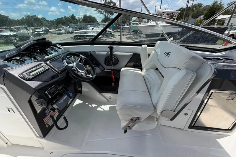 Slide: The Image of Cockpit of 2015 Monterey 288SS Super Sport boat with steering wheel and controls. - 31