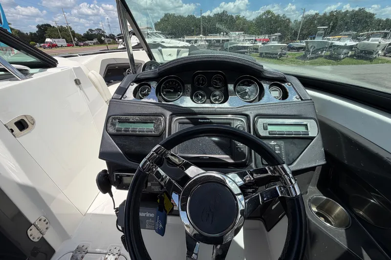 Slide: The Image of Dashboard of a 2015 Monterey 288SS Super Sport boat with steering wheel and gauges. - 32