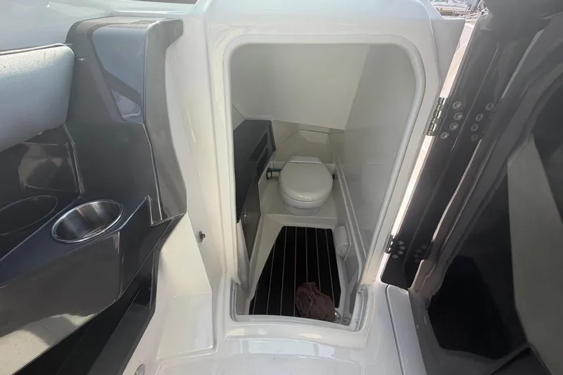Slide: The Image of Interior of 2015 Monterey 288SS Super Sport boat featuring a compact marine toilet. - 18
