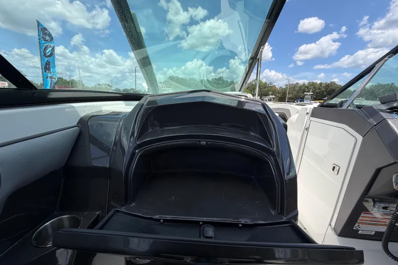 Slide: The Image of 2015 Monterey 288SS Super Sport boat interior with open storage compartment under blue sky. - 45