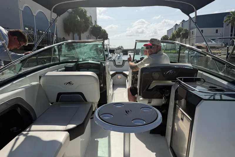 Slide: The Image of 2015 Monterey 288SS Super Sport boat interior with passengers, docked near waterfront buildings. - 16