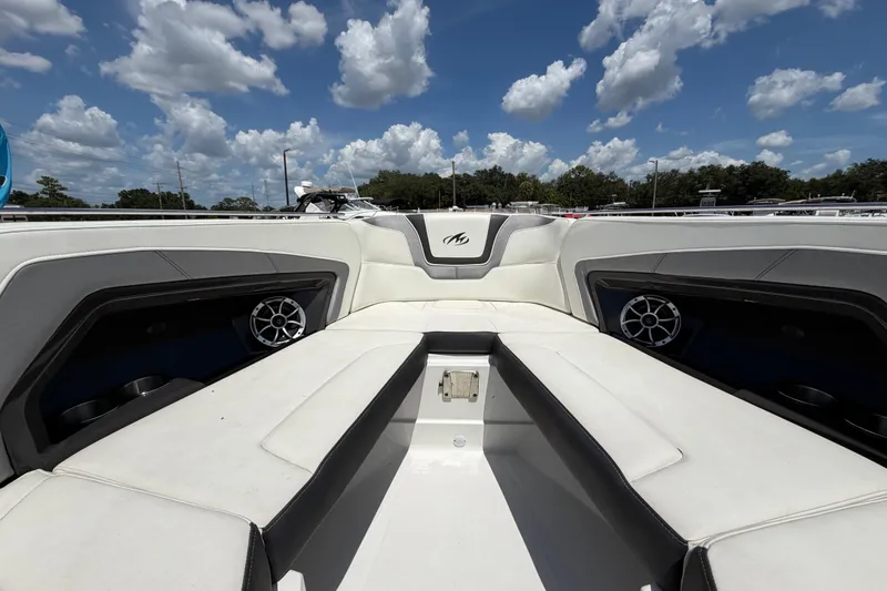 Slide: The Image of 2015 Monterey 288SS Super Sport boat interior with white seating under a blue sky. - 52