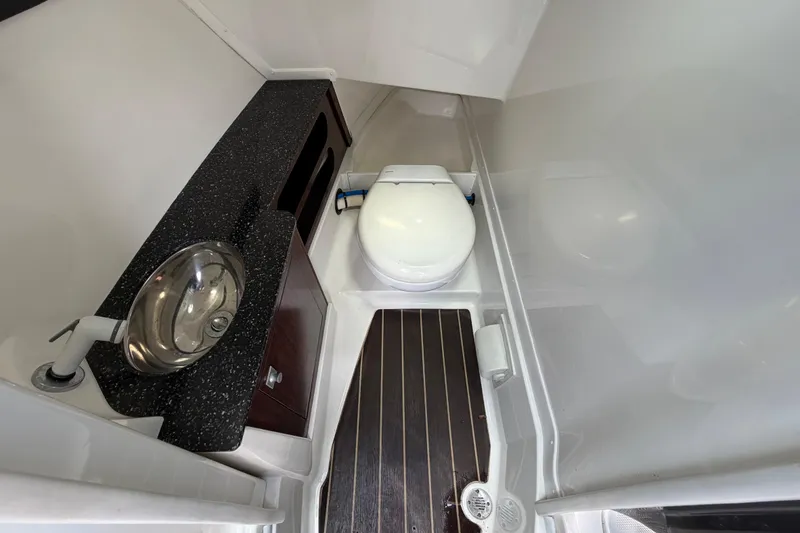 Slide: The Image of Interior of 2015 Monterey 288SS Super Sport boat bathroom with sink and toilet. - 47