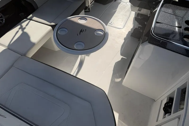 Slide: The Image of Interior of a 2015 Monterey 288SS Super Sport boat with seating and table. - 17