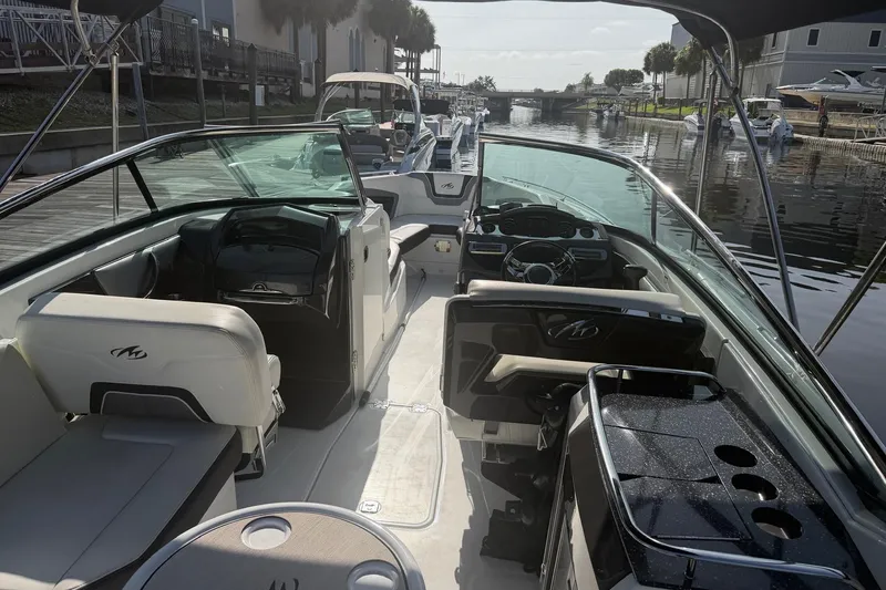 Slide: The Image of Interior view of a 2015 Monterey 288SS Super Sport boat docked by the water. - 14