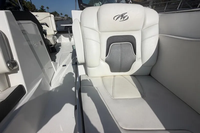Slide: The Image of Interior seating of a 2015 Monterey 288SS Super Sport boat, featuring white upholstery. - 24