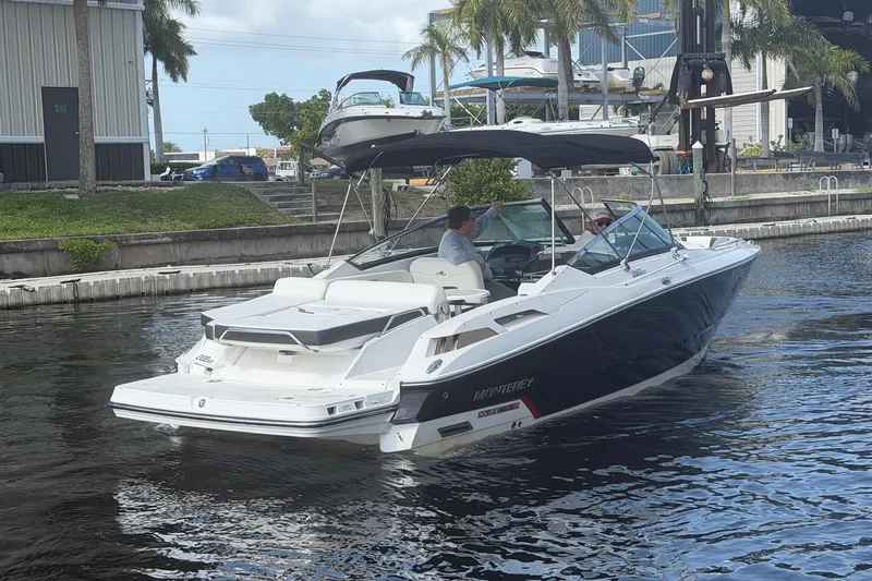 Slide: The Image of 2015 Monterey 288SS Super Sport boat cruising on a canal near a marina. - 3