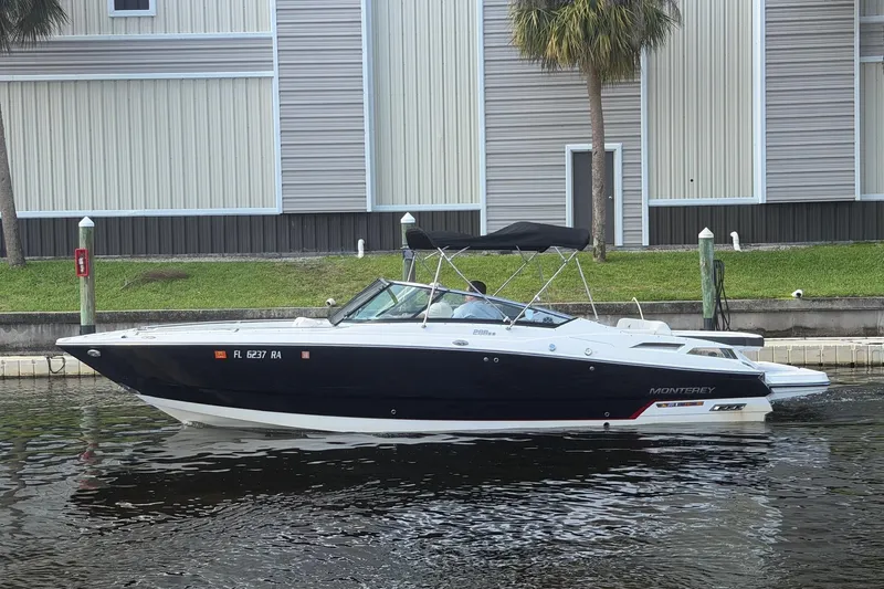 Slide: The Image of 2015 Monterey 288SS Super Sport boat docked by a waterfront building. - 7