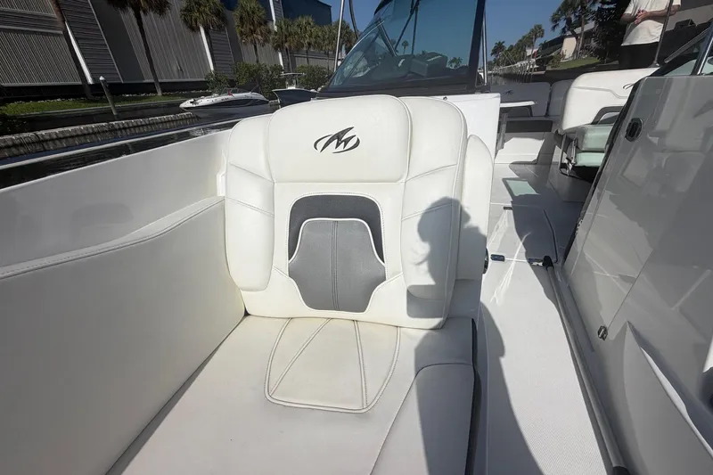 Slide: The Image of White leather seat on 2015 Monterey 288SS Super Sport boat, docked near palm trees. - 25