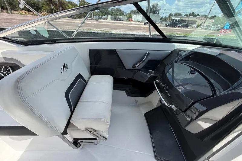 Slide: The Image of Interior of a 2015 Monterey 288SS Super Sport boat, featuring seating and dashboard. - 43