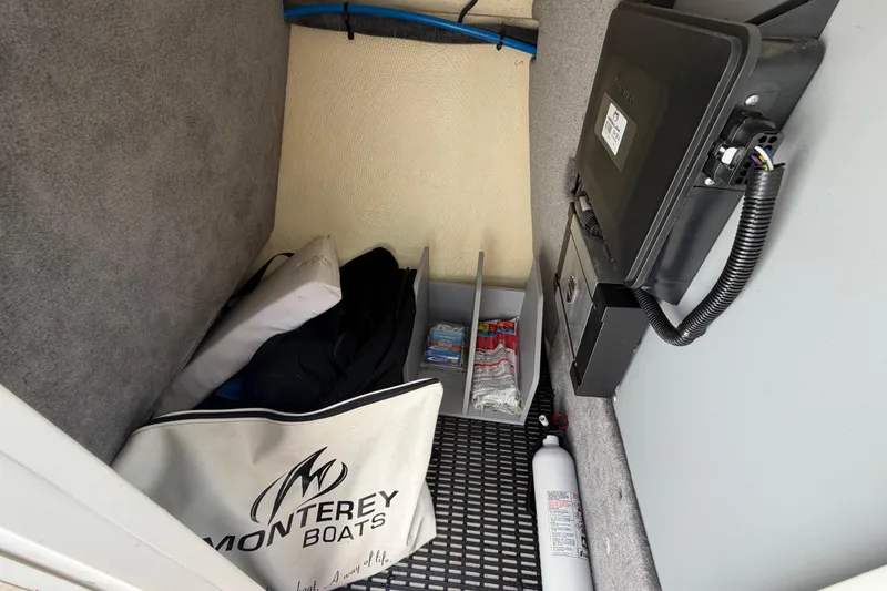Slide: The Image of Storage compartment in a 2015 Monterey 288SS Super Sport boat with safety equipment and accessories. - 50