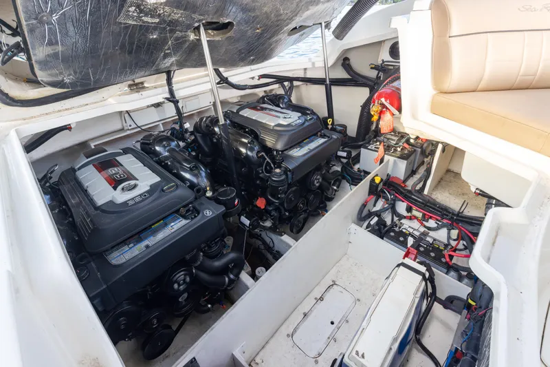 Slide: The Image of Engine compartment of a 2016 Sea Ray SLX 350 boat, showcasing dual engines and wiring. - 11